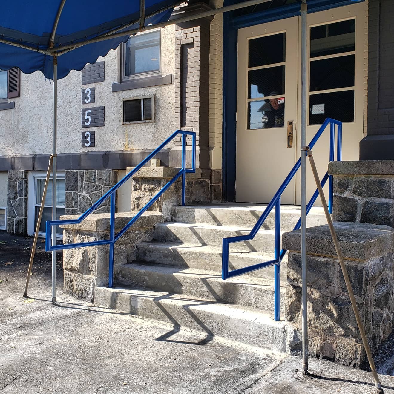 stone stairs with blue railing